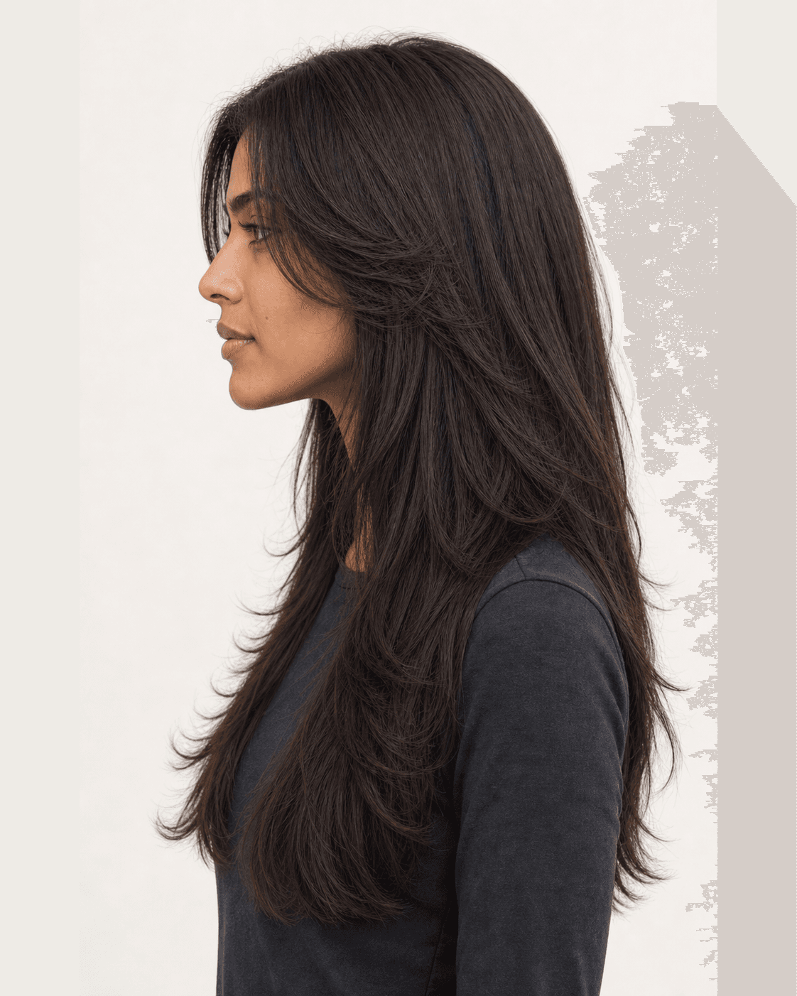 Side profile of a butterfly cut showing graduated face-framing layers and long length