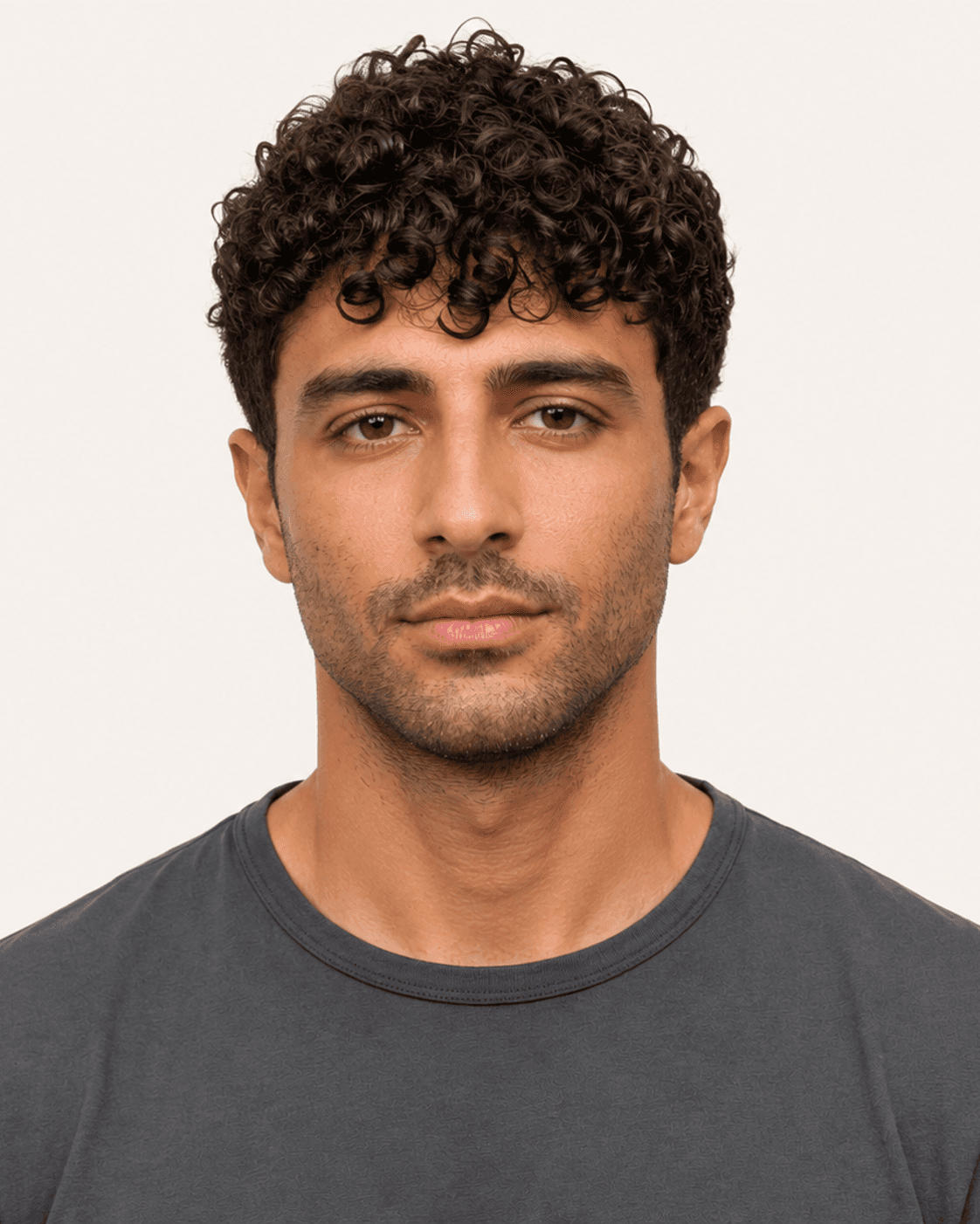 Front view of a curly fringe crop with separated forehead ringlets
