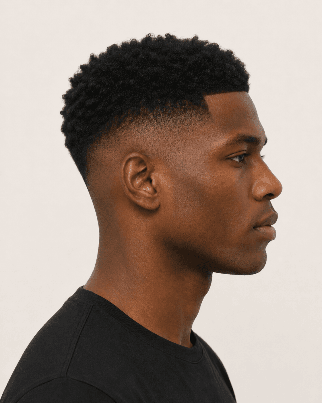 Side profile of a low skin fade showing the bare-to-length transition and ear contour