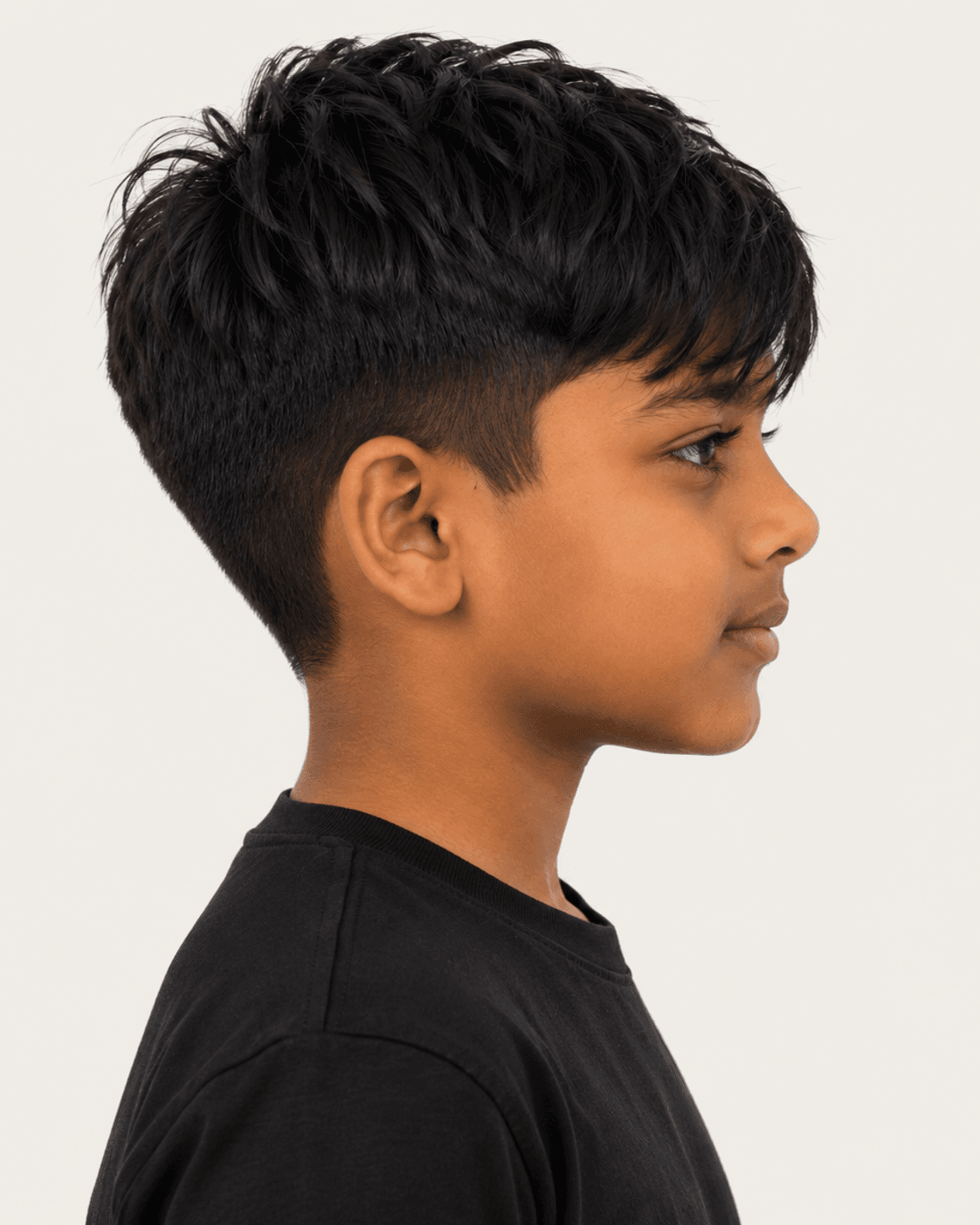 Side profile of a child-safe textured fringe reference showing a fuller upper field, close ear contour, and forward fringe fall