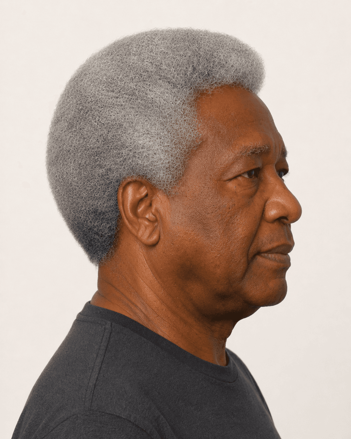 Side profile of a natural grey afro showing the even rounded silhouette