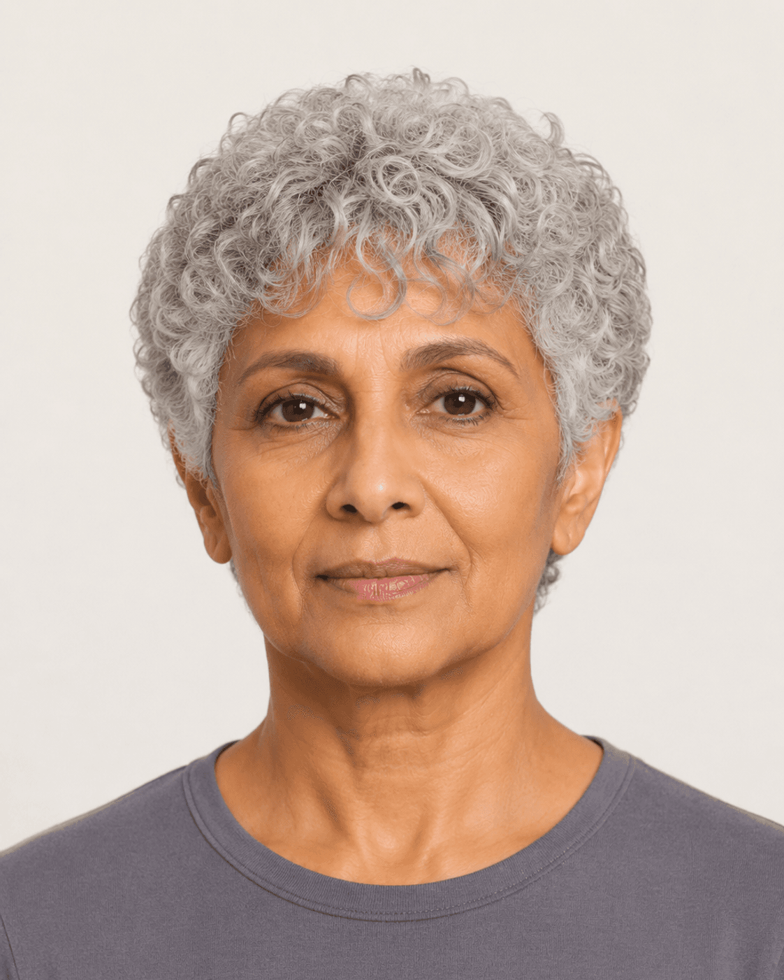Front view of natural silver curls with full crown volume and a soft curl fringe