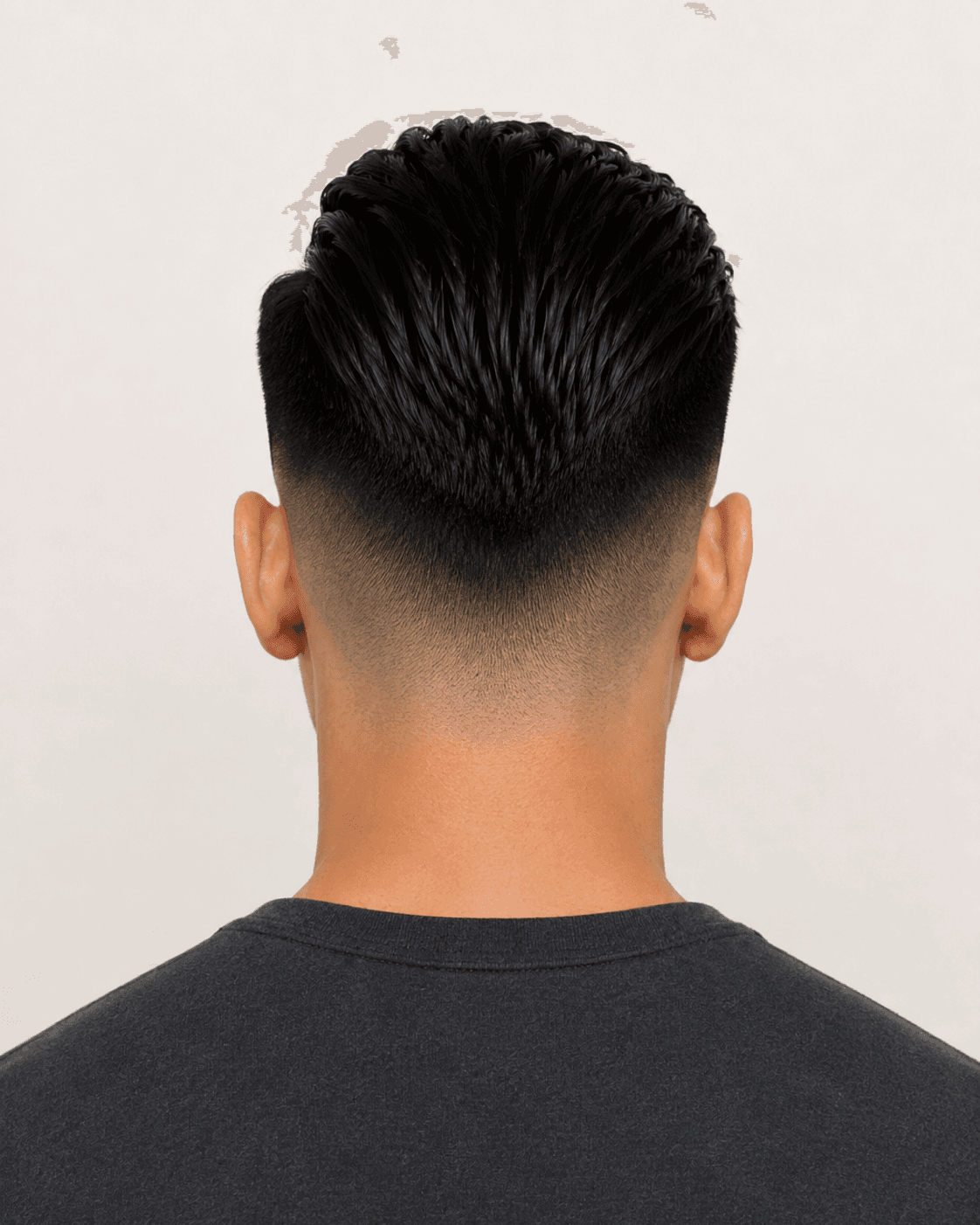 Rear view of a modern pompadour with mid fade showing the fade wraparound and tapered nape