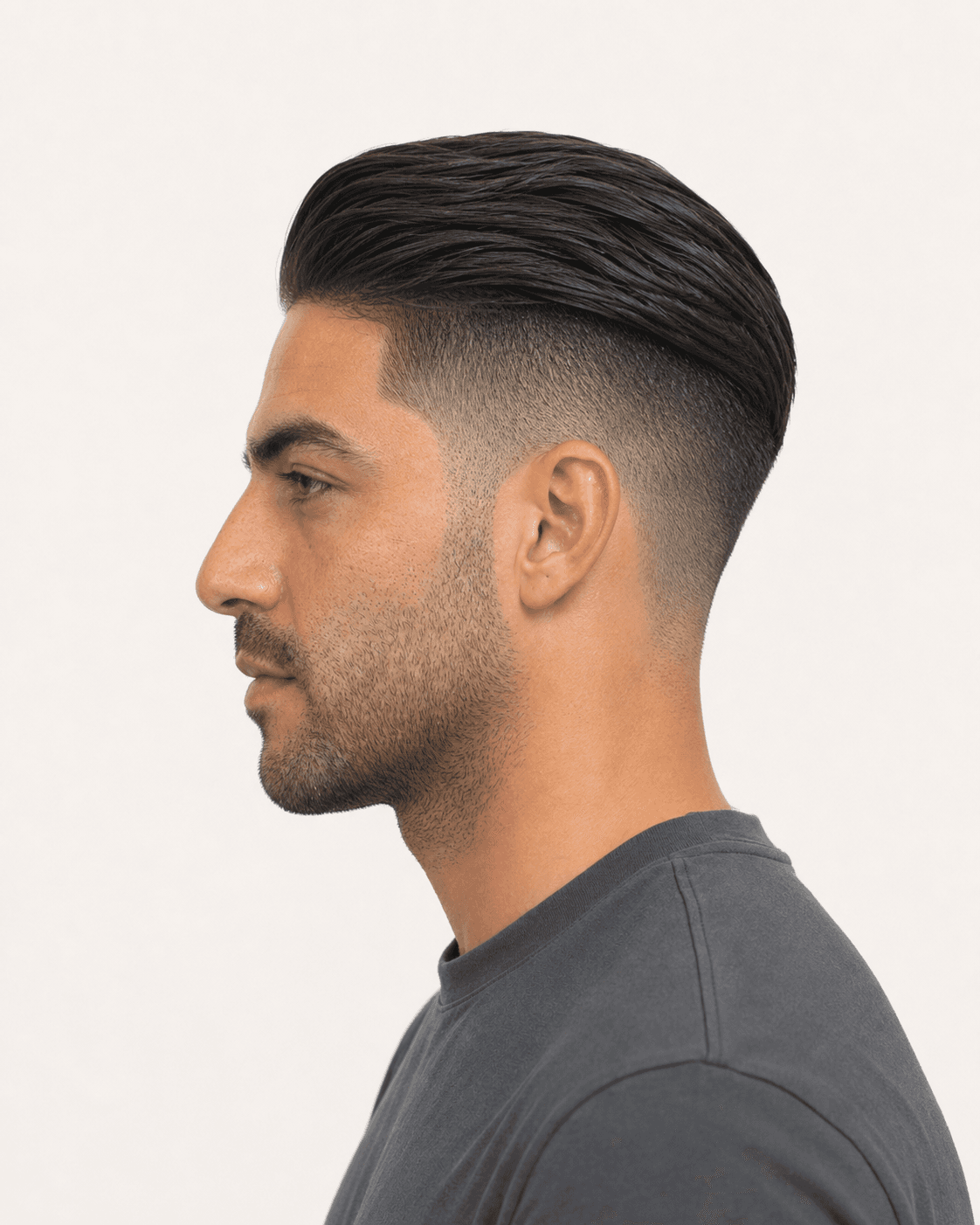 Side profile of a slicked-back undercut showing the long top and high fade gradient