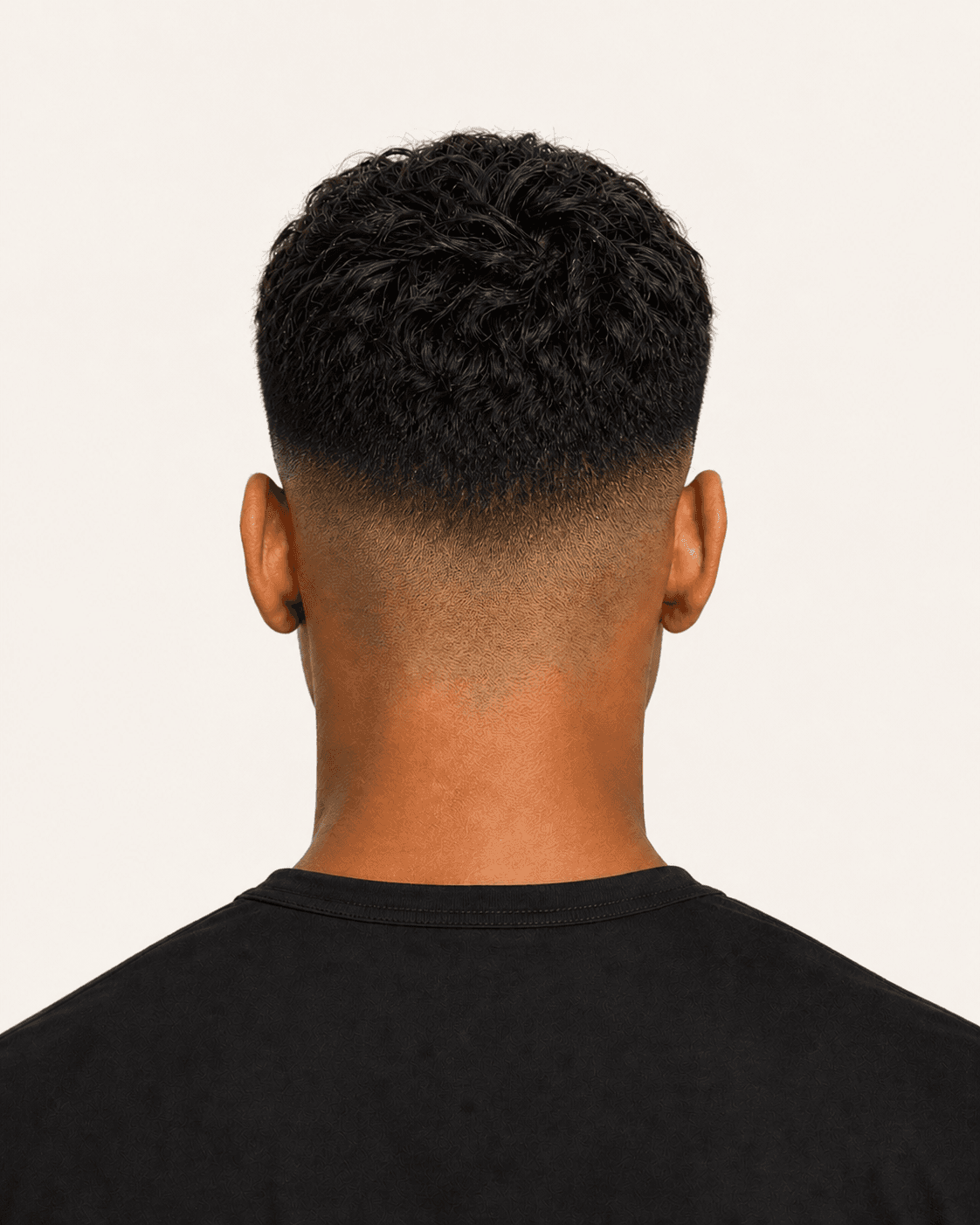 Rear view of a textured French crop showing the fade gradient, crown, and natural neckline